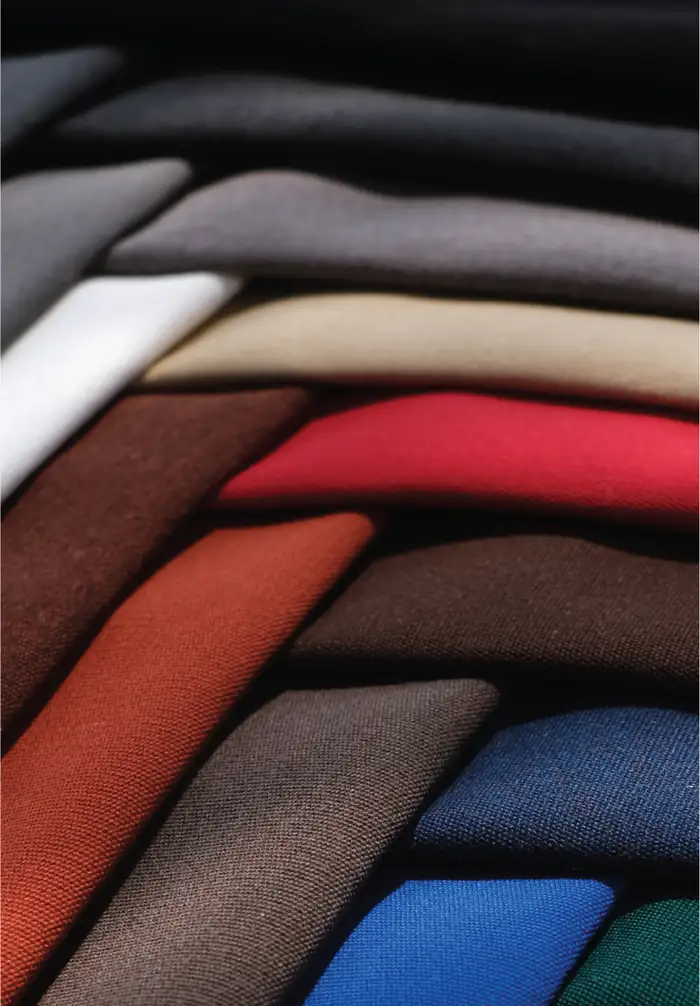 Stack of Sunproof Nova solution-dyed acrylic outdoor fabrics in red, orange, blue and neutrals